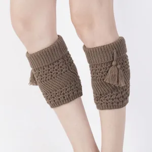 Coffee brown cable knit leg warmers with tassel details for women on white background