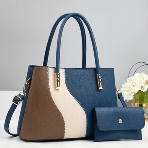 Detail of color-block tote bag and matching pouch with pebbled leather texture