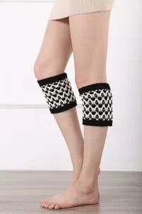 Dettaglio degli scaldamuscoli in maglia bianconeri con motivo a onde e texture in lana spessa