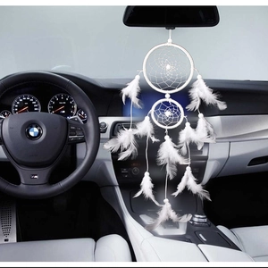 Rainbow dream catcher car hanging with white feathers on rearview mirror