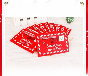 Detail of red felt Christmas envelope ornaments with Santa Claus postal prints