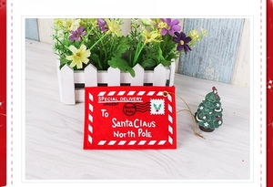 Detail of red felt Christmas envelope for Santa Claus with white stitching and hanging rope
