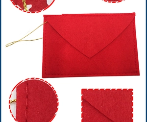 Close-up of red felt Christmas envelope with gold cord and detailed edge stitching