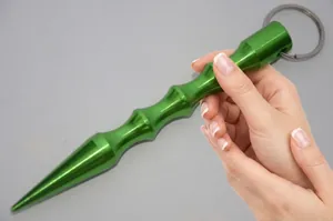 Macro detail of a green aluminum kubotan featuring ergonomic finger grooves and a sharp tip