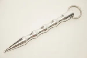 Silver metal self-defense keychain with textured grip and sharp tapered tip detail