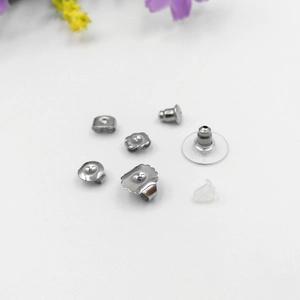 Close-up of golden stainless steel earring backs showing 316L hallmark and butterfly style