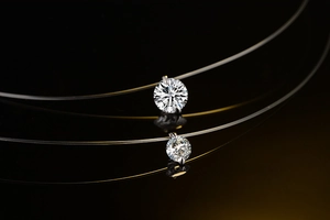 Macro shot of clear fishing line invisible necklace with two brilliant-cut zircon pendants
