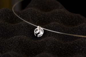 Macro shot of a S925 sterling silver floating necklace with a brilliant round zircon