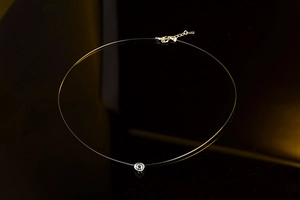 Close-up of heart-shaped zircon pendant on invisible line with S925 silver clasp