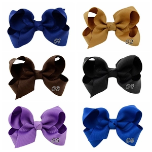 Detail of colorful grosgrain ribbon hair clips in six vibrant shades and grid layout