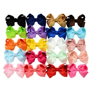 Set of 20 colorful bow hair clips in various vibrant shades on a white background