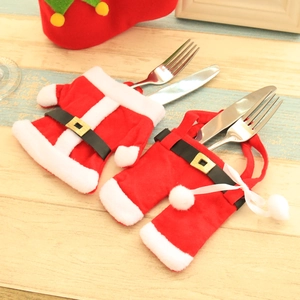 Christmas silverware holder featuring Santa jacket and pants on wooden background