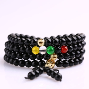 Macro shot of multi-strand beaded bracelet with colorful glass accents and gold details
