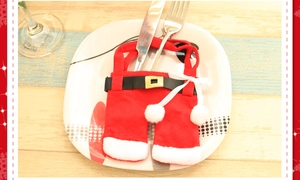 Detail of Santa Claus pants cutlery holder on a plate for Christmas table decor