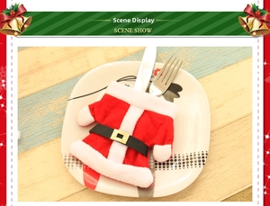 Detailed view of Santa suit cutlery holder with knife and fork on a white porcelain plate