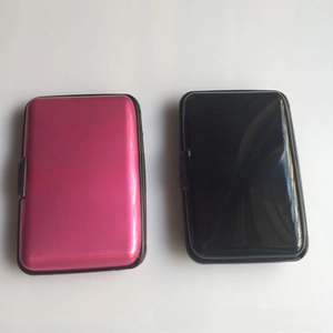 Detail view of pink and black aluminum credit card holders with secure side clasps