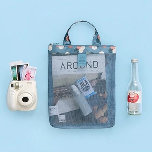 Blue mesh beach storage bag with floral trim for summer swimwear and toiletries