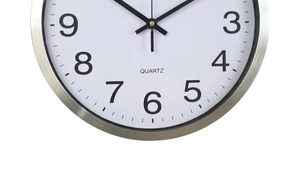 Detail of a 30cm metal wall clock featuring a silver brushed frame and quartz movement