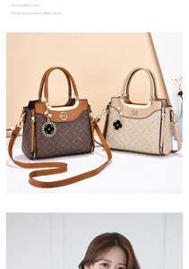Close-up of retro logo patterned synthetic leather handbag with metal ring and clover charm