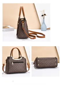 Detail view of brown vintage printed handbag with back zip pocket and metal feet