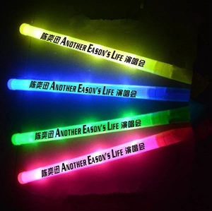 Detail of four colorful LED glow sticks for Eason Chan concert in dark setting