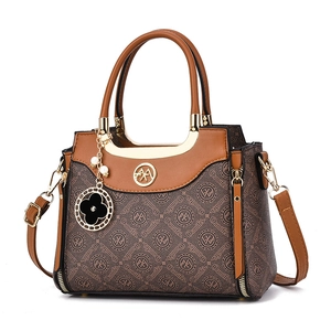 Brown leather crossbody bag with logo print pattern, dual handles and clover charm