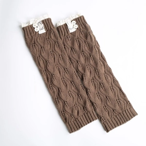 Detail of dark coffee knit leg warmers featuring white lace trim and two white buttons