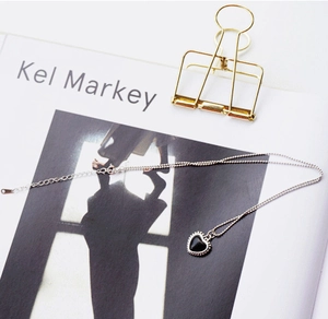 Detail view of S925 sterling silver ball chain with a black heart-shaped pendant