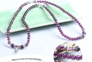 Detail of purple crystal beaded bracelet with vintage silver hollow flower spacers
