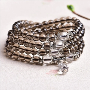 Elegant multilayer beaded bracelet with purple glass gems and floral pendant