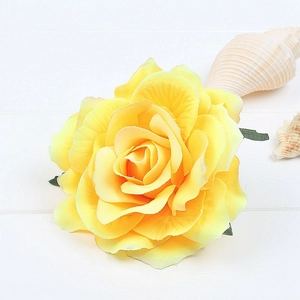 Detailed top view of a realistic yellow artificial silk rose flower for hair accessories