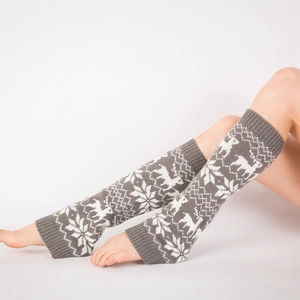 Detail of Fair Isle knit leg warmers with grey reindeer and snowflake winter patterns