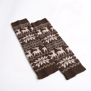 Detailed knit texture of reindeer and snowflake winter pattern leg warmers in coffee brown