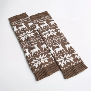 Close-up of brown knitted leg warmers featuring white reindeer and snowflake festive patterns