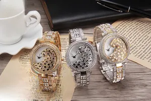 Detailed macro shot of luxury quartz watches with leopard dial and crystal bracelet
