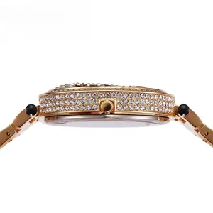 Detail of gold watch case featuring side-set crystals and leopard-patterned steel band