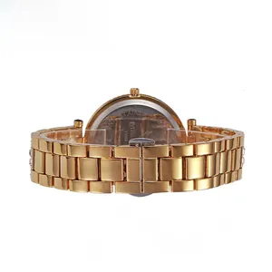 Detailed back view of gold stainless steel watch band with engraved brand logo and text