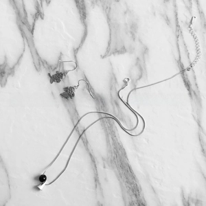 Detail of 925 sterling silver jewelry set with kanji love earrings and black agate bead