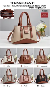 Close-up of pebble leather handbag showing three inner compartments and size 32x14x22cm