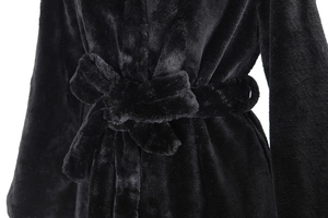Detail of the waist drawstring tie on a plush black faux fur coat for women