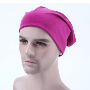 Detailed close-up of a magenta cotton knit slouchy beanie cap on a male head mannequin