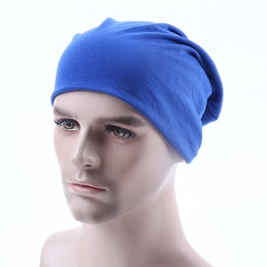 Three-quarter view of a blue knitted beanie showing the top folds and ribbed texture
