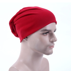 Side view of a bright red slouchy beanie hat for adults displayed on a white head mannequin