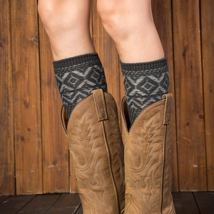 Retro grey geometric jacquard leg warmers styled with vintage brown western boots