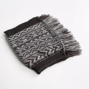 Detail of bohemian knit leg warmers featuring wave patterns and stylish fringe trim