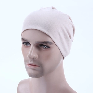 Detailed side view of a beige stretch knit dome cap on a model for a snug fit