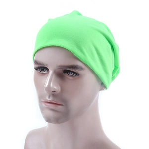Detail of neon green knitted beanie on a head model with soft ribbed fabric texture
