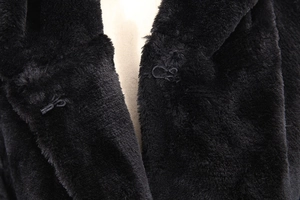 Close-up of the black faux fur coat collar showing the texture and the metal hook fastener