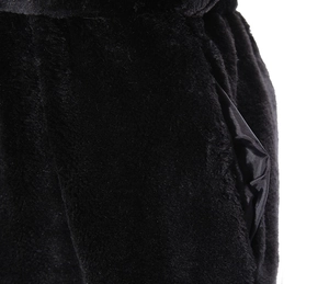 Detailed macro view of black faux fur texture with silky satin pocket lining on coat