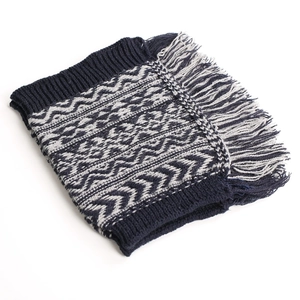 Detail of knitted leg warmer with navy and grey geometric patterns and fringe edges